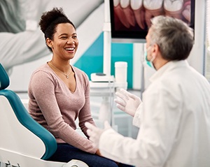 Patient smiling while talking to dentist