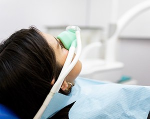 Patient inhaling nitrous oxide through nasal mask