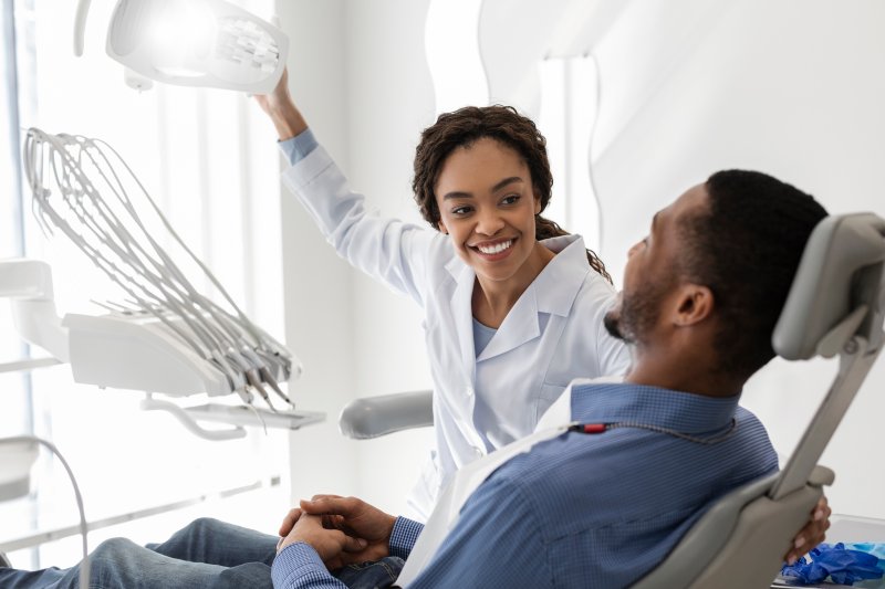 Patient smiling with their dentist and new dental implants