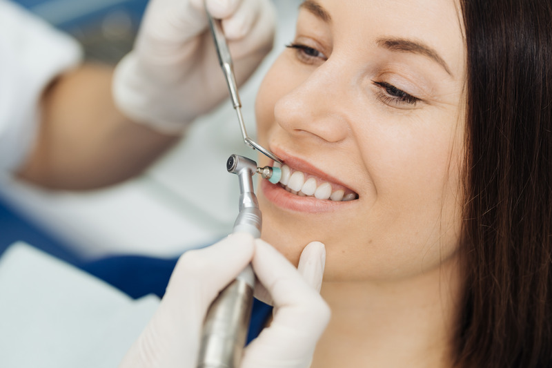 Patient smiling with prosthodontist after removing Invisalign attachments